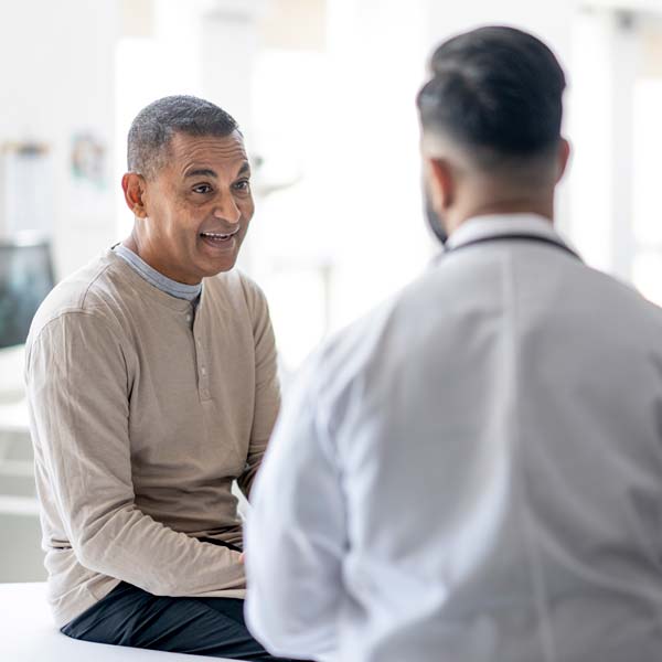 doctor talking to older male patient