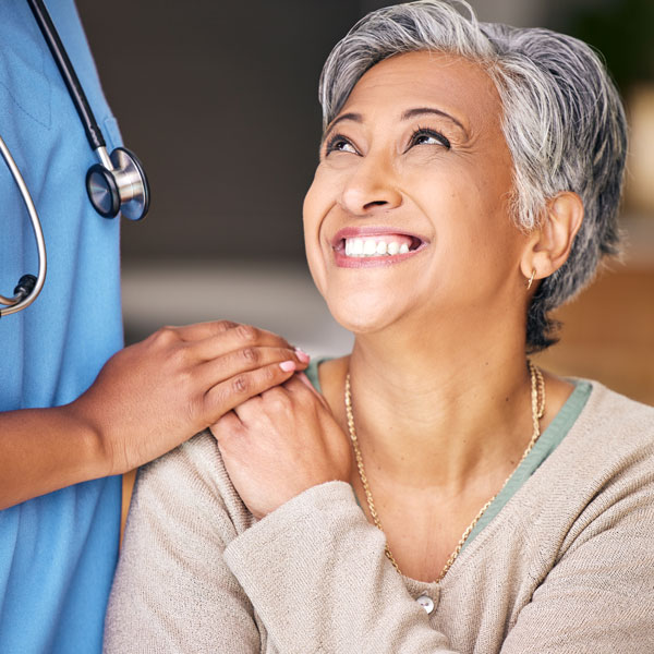 nurse comforting mature female patient