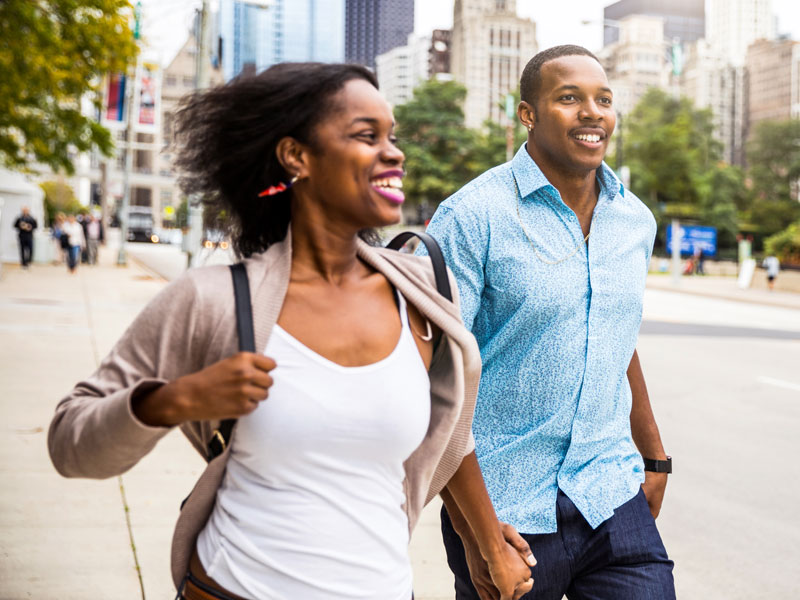 adult couple walking through city streets