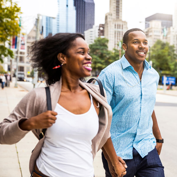 adult couple walking through city streets